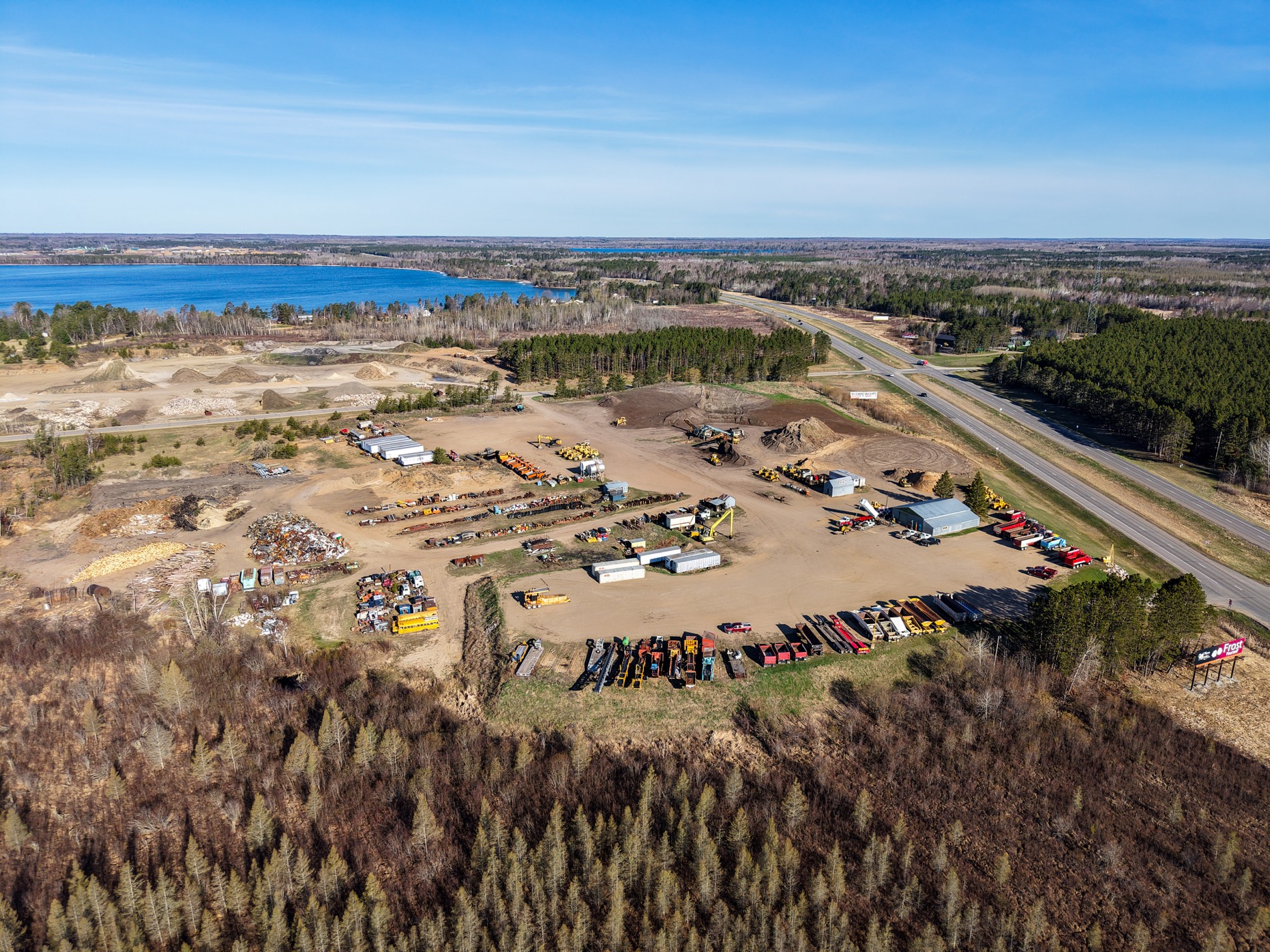 Organized equipment yard with stockpiles and shop